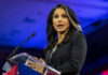 Woman speaking at a podium with microphone
