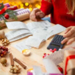 Person calculating expenses with receipts and decorations