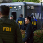 FBI Rescues 115 Children, Arrests 205 Predators in Five-Day Sweep FBI and SWAT team gathered near vehicle.