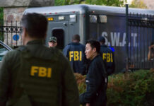 FBI Rescues 115 Children, Arrests 205 Predators in Five-Day Sweep FBI and SWAT team gathered near vehicle.