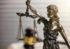 Impeachment Heat Forces Sudden Recusal Blindfolded lady justice statue with scales and gavel
