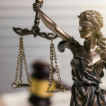 Impeachment Heat Forces Sudden Recusal Blindfolded lady justice statue with scales and gavel