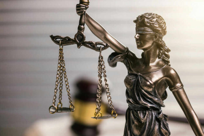 Blindfolded lady justice statue with scales and gavel