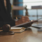 Injunction Shields ActBlue — What’s Being Hidden? Judge's gavel on desk with person writing in background