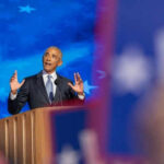 Records Shred Obama’s ‘Same Values’ Claim Man speaking at podium with blue starry background