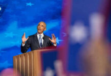 Records Shred Obama’s ‘Same Values’ Claim Man speaking at podium with blue starry background