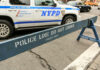 NYPD police barricade on city street with vehicles