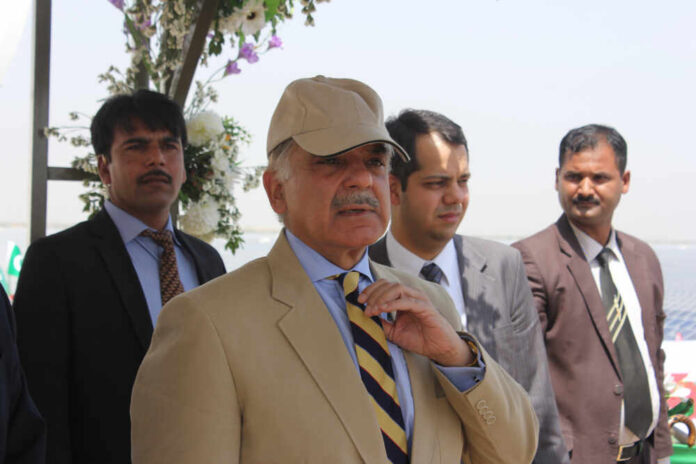 Bahawalpur,,Punjab,Pakistan,-,05,May,2015,:,Chief,Minister A group of men in formal attire at an outdoor event, with one man wearing a cap
