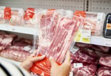 UK Pushes Tobacco-Style Bacon and Ham Warnings A man stands in front of empty meat shelves in a grocery store