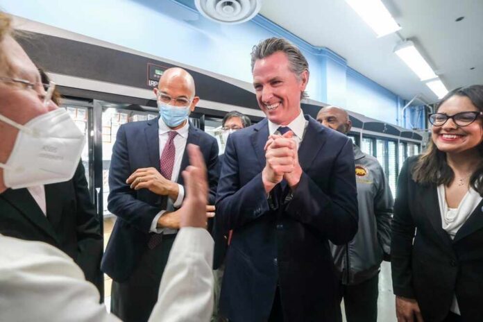 Ca,Gov.,Gavin,Newsom,Announces,A,Partnership,With,Civica,Rx Group of people engaged in a lively discussion during a public event