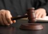 Minnesota Shock — Killer Dodges Execution A judge's hand holding a gavel above a wooden block