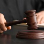 Minnesota Shock — Killer Dodges Execution A judge's hand holding a gavel above a wooden block