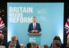 Musk Backs Farage Rival — Could Hand Labour Victory A politician delivering a speech at a podium with British flags in the background