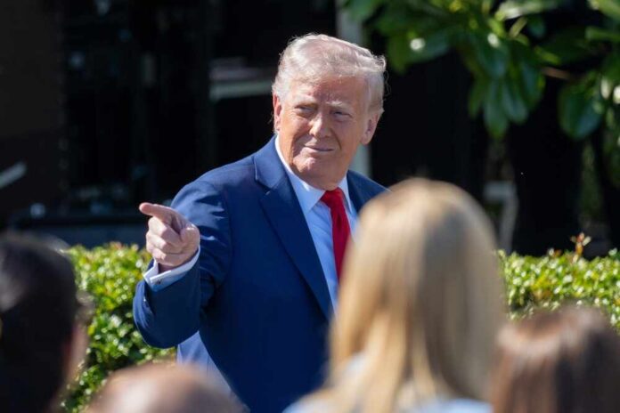 Washington,Dc,,United,States,,April,28,2025:president,Donald,Trump,Hosts A man in a blue suit and red tie gestures while speaking to a crowd