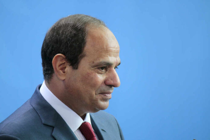 Berlin,,Germany,-,June,3,,2015:,Egyptian,President,Abdel,Fattah A serious-looking man in a suit with a red tie, surrounded by blurred figures