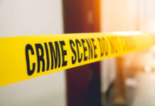 Yellow crime scene tape with the words 'CRIME SCENE DO NOT CROSS'