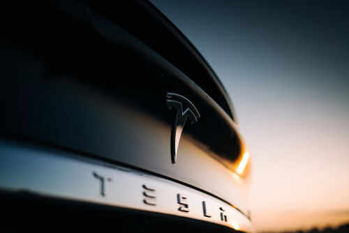tesla-car1491230117jpg Closeup of Tesla car logo at sunset
