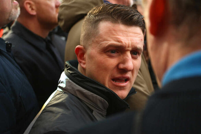 tommy-robinson1257364525jpg Man speaking intensely in a crowded outdoor setting