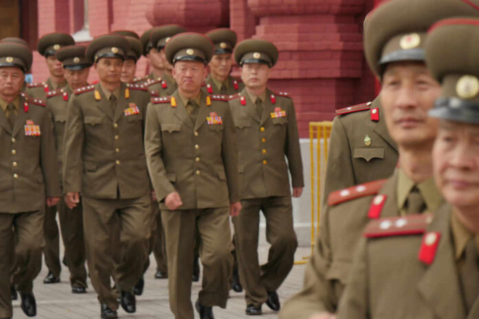 395321938 Military officers marching together in uniform.