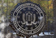 FBI Rushes In After Shocking Graham Collapse FBI seal on a concrete wall outdoors