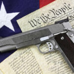 Pistol on Constitution and flag background.
