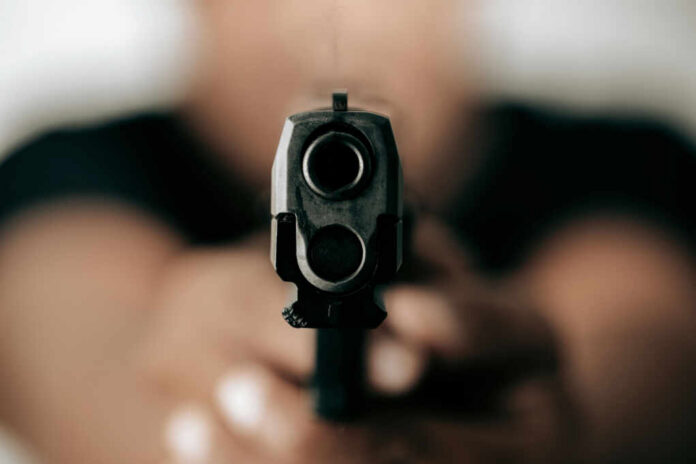 Gun barrel pointed directly at the camera