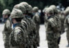 Soldiers in camouflage uniforms standing in formation