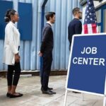 Lowest Since ’69, But Who’s Hiring? People standing in line outside a job center entrance