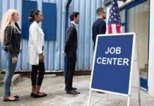 People standing in line outside a job center entrance