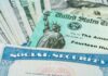 Social Security card and U.S. Treasury check on cash