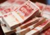 Capital Trap Slams China’s Savers Stacks of Chinese banknotes arranged neatly