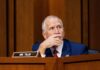 No Meeting, No AG: GOP Ultimatum A politician sitting at a desk with a thoughtful expression during a hearing