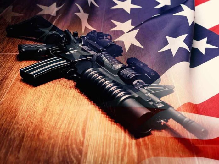 Assault rifle on wooden floor overlaid with American flag