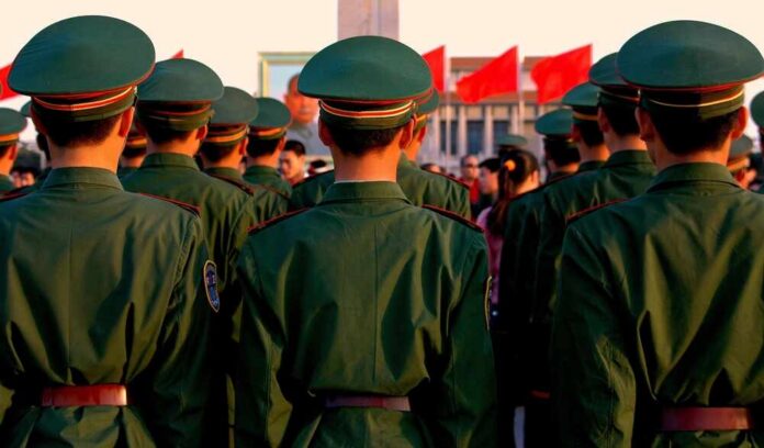 Beijing,,China,-,May,1,,2005:,Rows,Of,Chinese,Soldiers A military missile system positioned on a grassy field during sunset