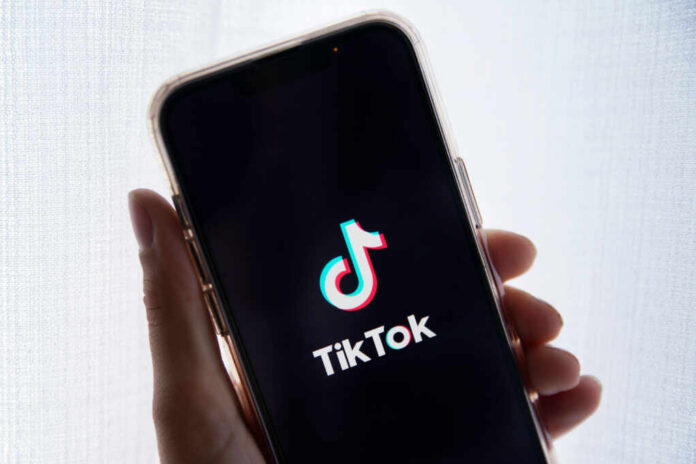 Smartphone displaying TikTok app logo on screen