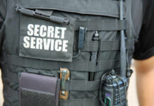 Stunning Security Lapses Around Trump Tactical vest with equipment and a visible service patch