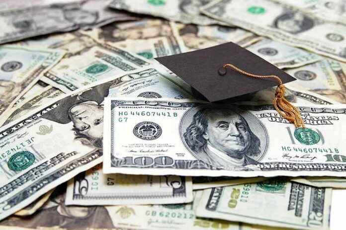 shutterstock_101980843 Graduation cap on a pile of US dollar bills