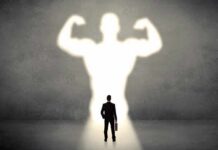 Exercise Without Sweat? Bioethics Alarm Bells Businessman with briefcase casts a large muscular shadow on wall