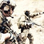 Drone-Killer Turret Unleashed on Truck Soldiers in camouflage gear with rifles in a sandy terrain