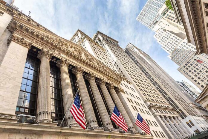shutterstock_1155913927 New York Stock Exchange facade with columns and American flags