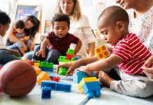 Audit Flags Chaos In Child-Care Payouts toddlers playing with colorful building blocks on a mat