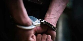 hands in handcuffs behind back