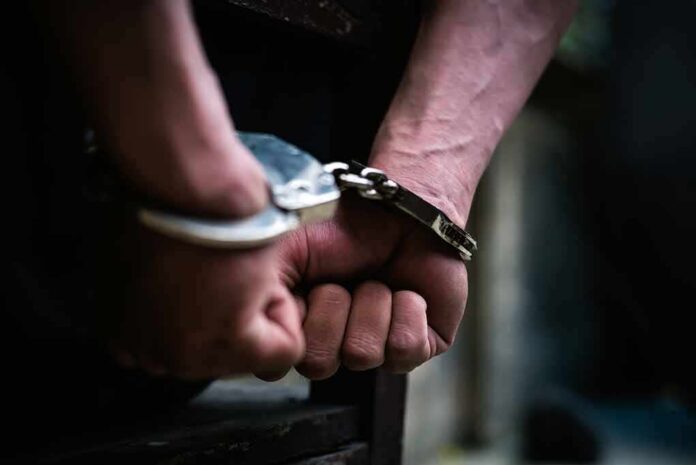 hands in handcuffs behind back