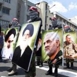 Nuclear Talk Inside Iran War Rooms? Protesters holding large portrait posters during a street march