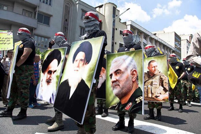 shutterstock_1414140161 Protesters holding large portrait posters during a street march