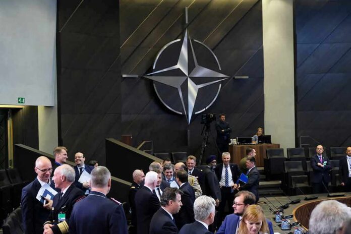 conference attendees under large star emblem in modern chamber