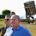 Netanyahu’s Hard Line Triggers U.S. Oversight two men standing near a missile defense launcher outdoors