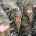 Veterans Dive In—PTSD Eased Under Ocean Giants U.S. flag patches on camouflage military uniforms