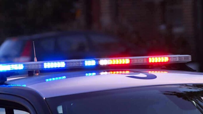 shutterstock_1571550244 Police car roof with flashing blue and red lights