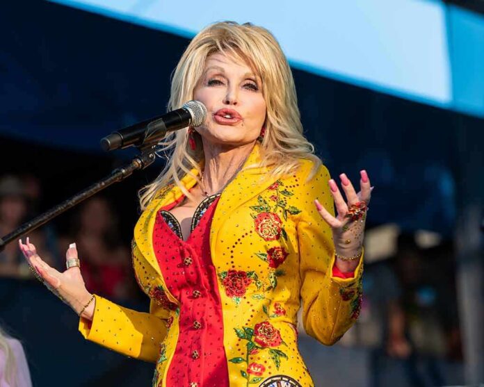 shutterstock_1596680992 Singer performing on stage in a bright yellow floral jacket